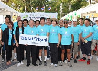 Dusit general manager, Chatchawal Supachayanont, third left, stands with Dr. Jirapol Sinthunava of the Green Leaf Foundation, fourth left, and other riders at the Pattaya Midnight Bike ride on Saturday, April 30.